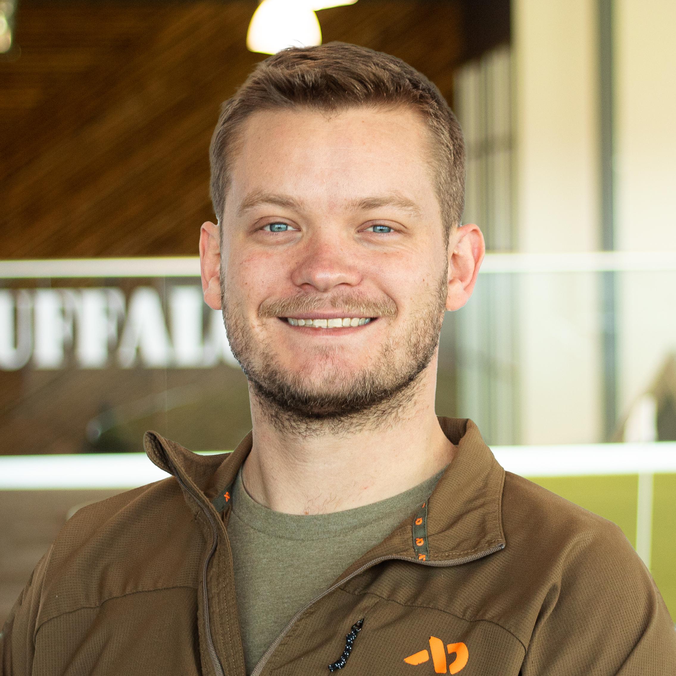 Ben Heckman smiling and standing in buffalo's office space.