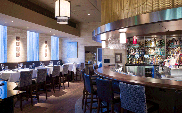 Bar and table seating at Eddie V's restaurant in Boston, ,MA.