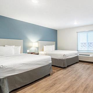 Two bed guest room inside of the WoodSpring Suites hotel in Redlands, CA.