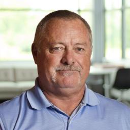Craig Abraham smiling in a bright, modern office.
