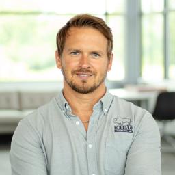 Chris Dickerson looking charming while in a bright, modern office.