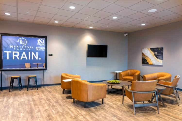 Member lounge seating area at Next Level Ranges.