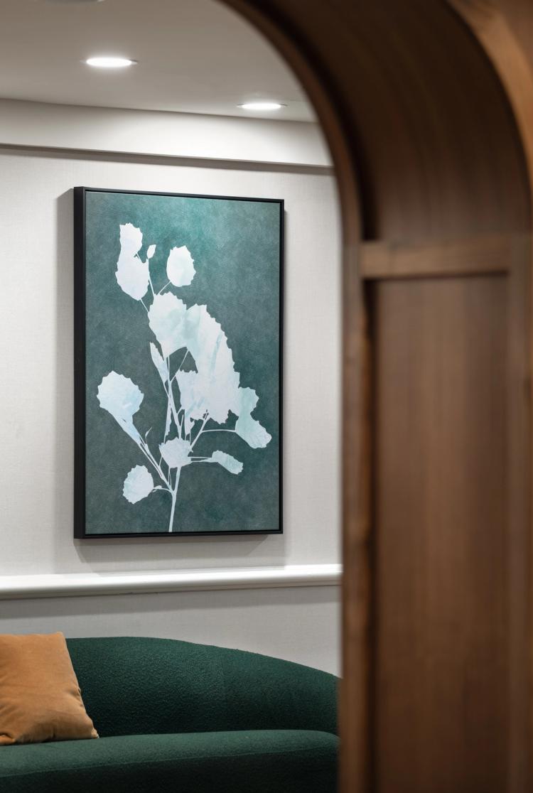 Floral artwork over green curved lounge seating