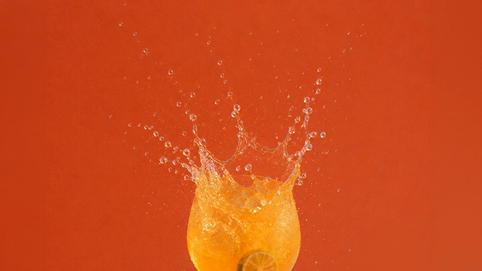 Rangu bottle and spritz on a table under palm leaves
