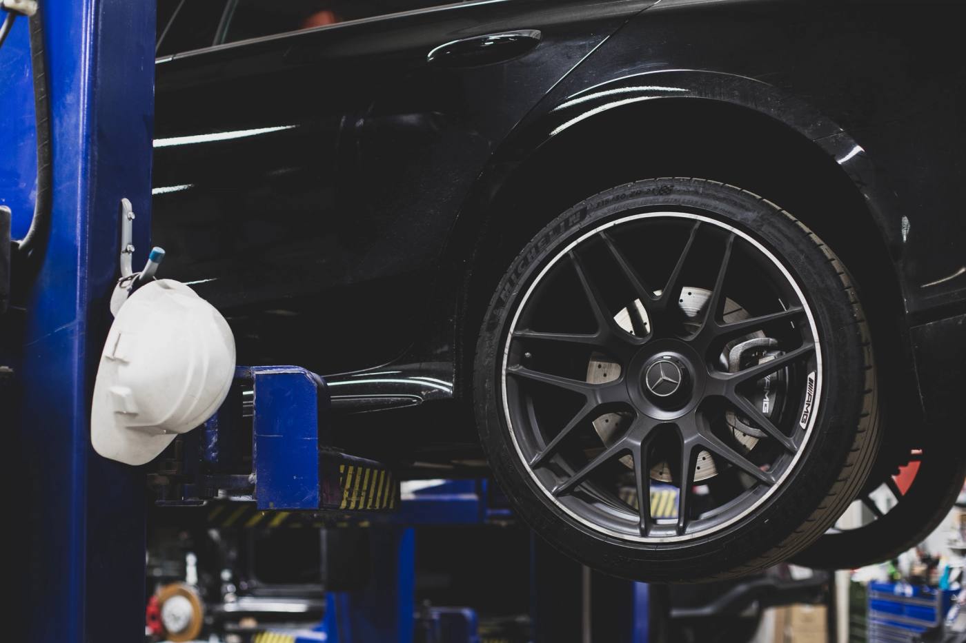 A vehicle up on a lift in the Carl's Collision shop