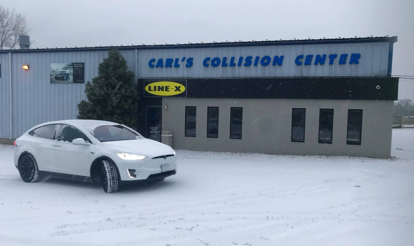 A vehicle at Carl's Collision on a snowy SouthCoast day