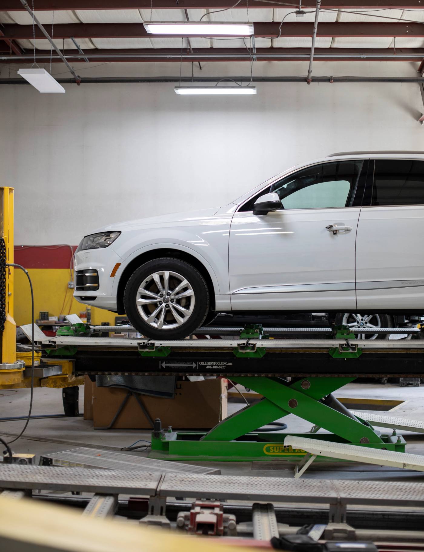 A vehicle on a frame rack as the shop assesses the repair