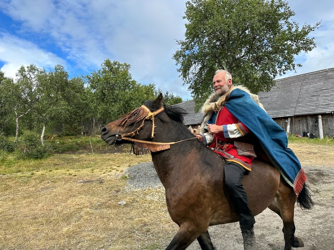 The chief rides a horse during the Lofotr Viking Festival