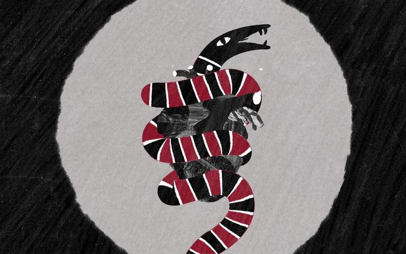 A striped snake coils around a sculptural heart in a black, white and red collage.