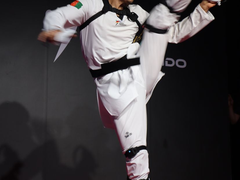 An athelete performing a high kick