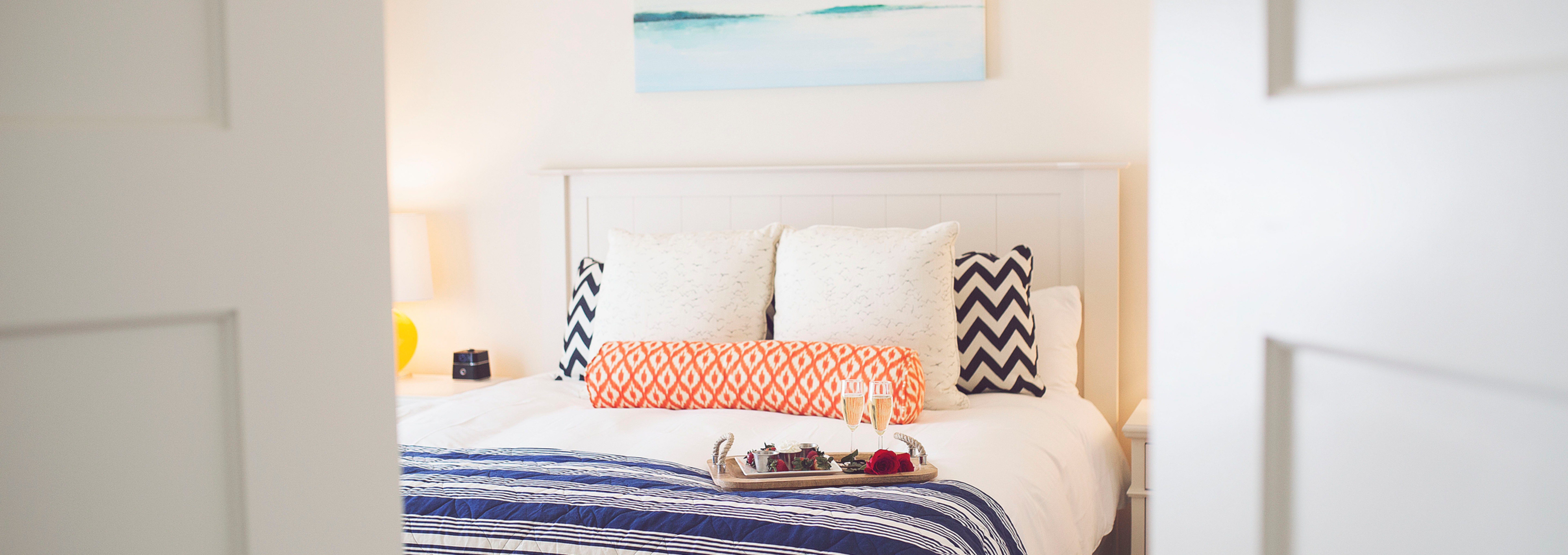 Chocolate covered strawberries on a bed in a bright bedroom