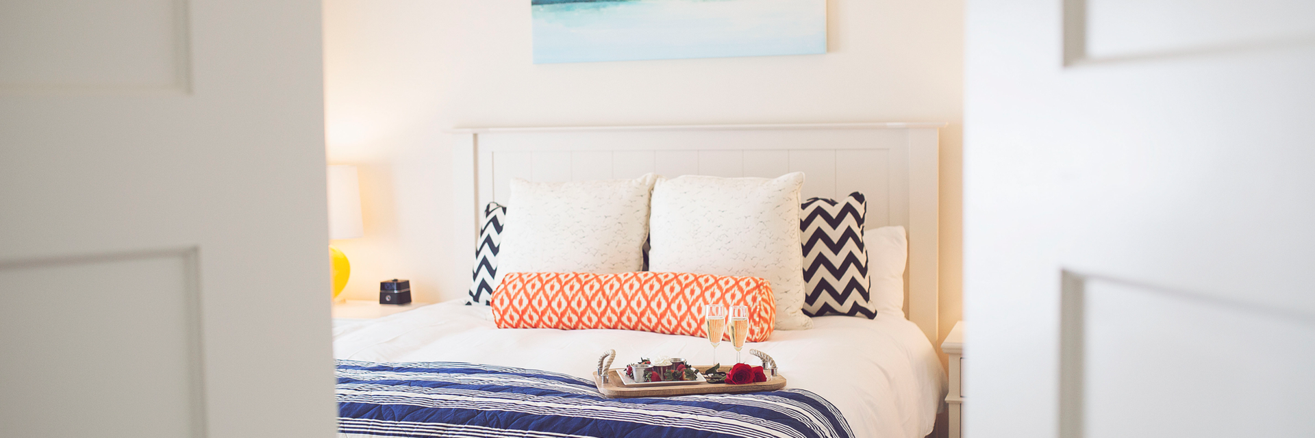Chocolate covered strawberries on a bed in a bright bedroom