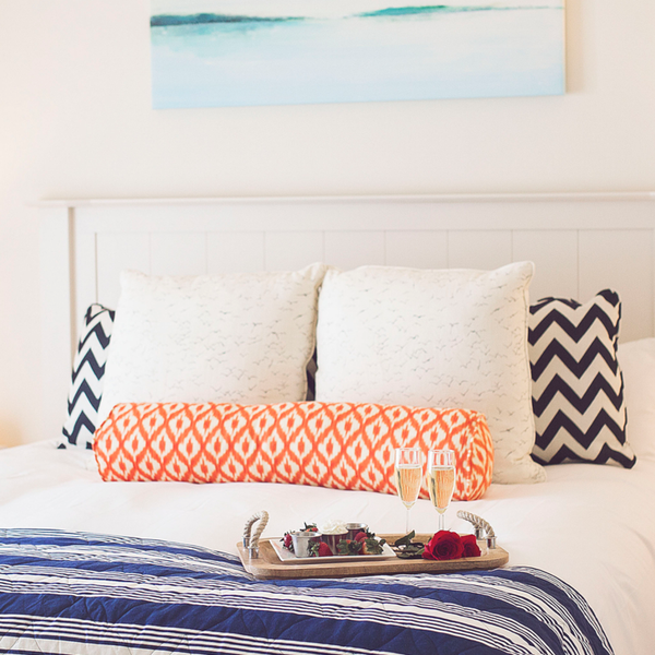 Chocolate covered strawberries on a bed in a bright bedroom