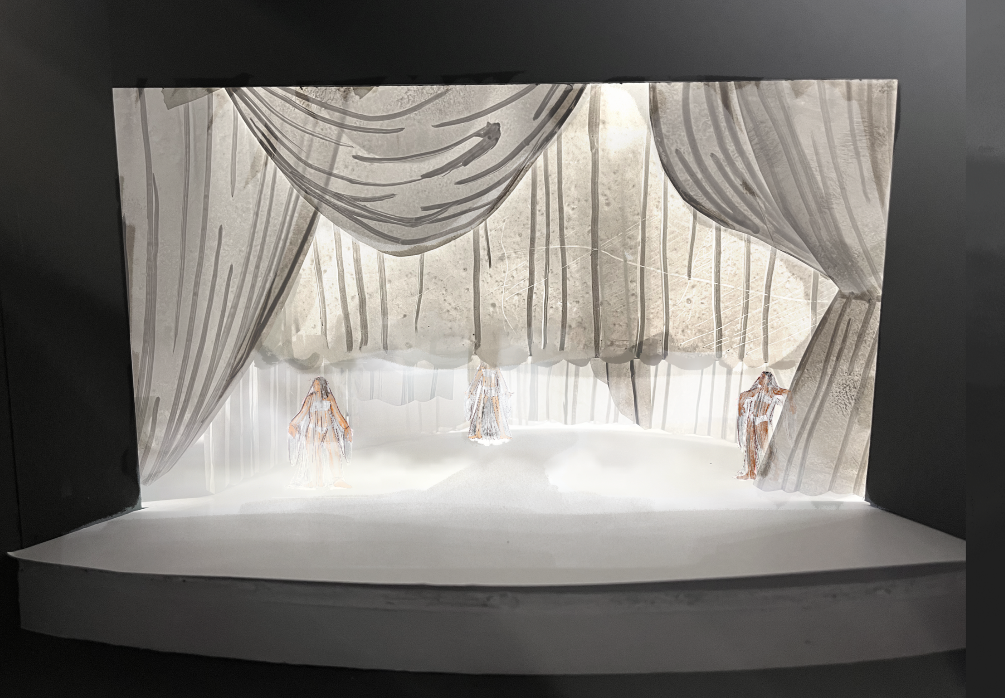 A stage design model featuring a minimalist, ethereal aesthetic. The set is draped in semi-transparent, flowing curtains with subtle, abstract markings