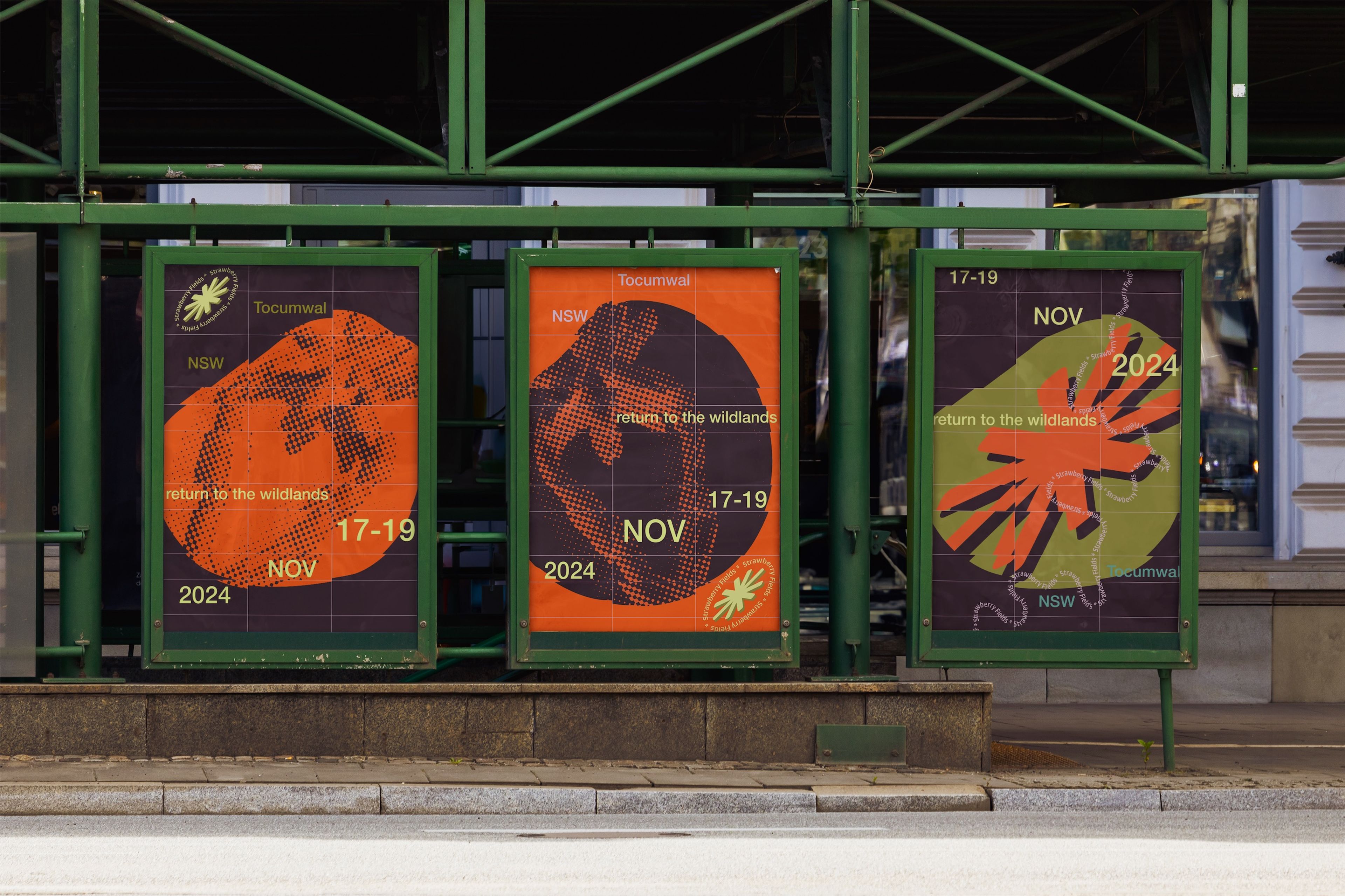 Series of three event posters in green metal frames promoting Strawberry Fields festival with the tagline 'Return to the Wildlands'. Each design features a large, abstract graphic in orange and black, overlaid with event details.