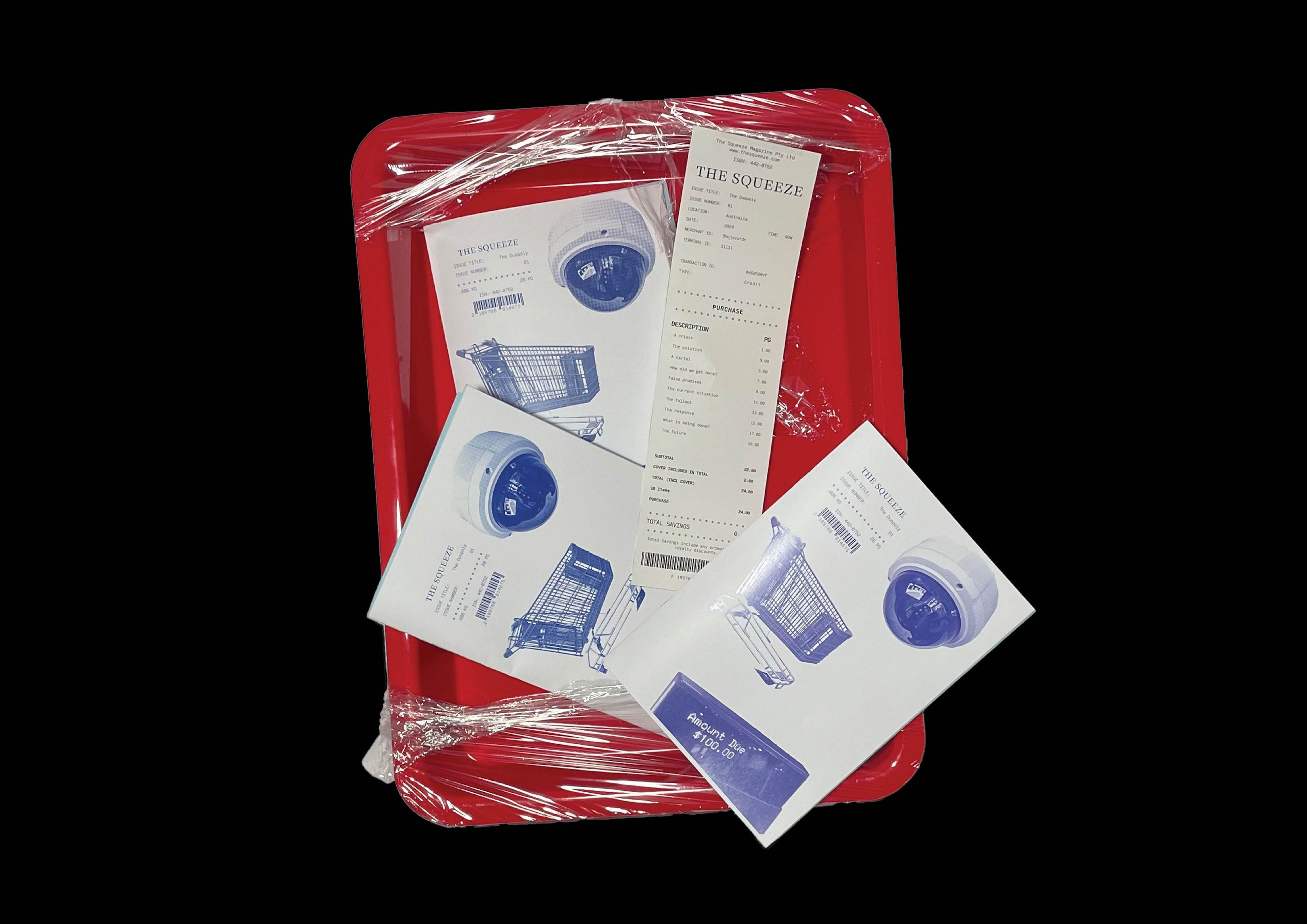 Three copies of 'The Squeeze' zine with blue illustrations of surveillance cameras and shopping carts, resting on a red plastic tray wrapped in plastic. A printed receipt with 'The Squeeze' branding lies atop.