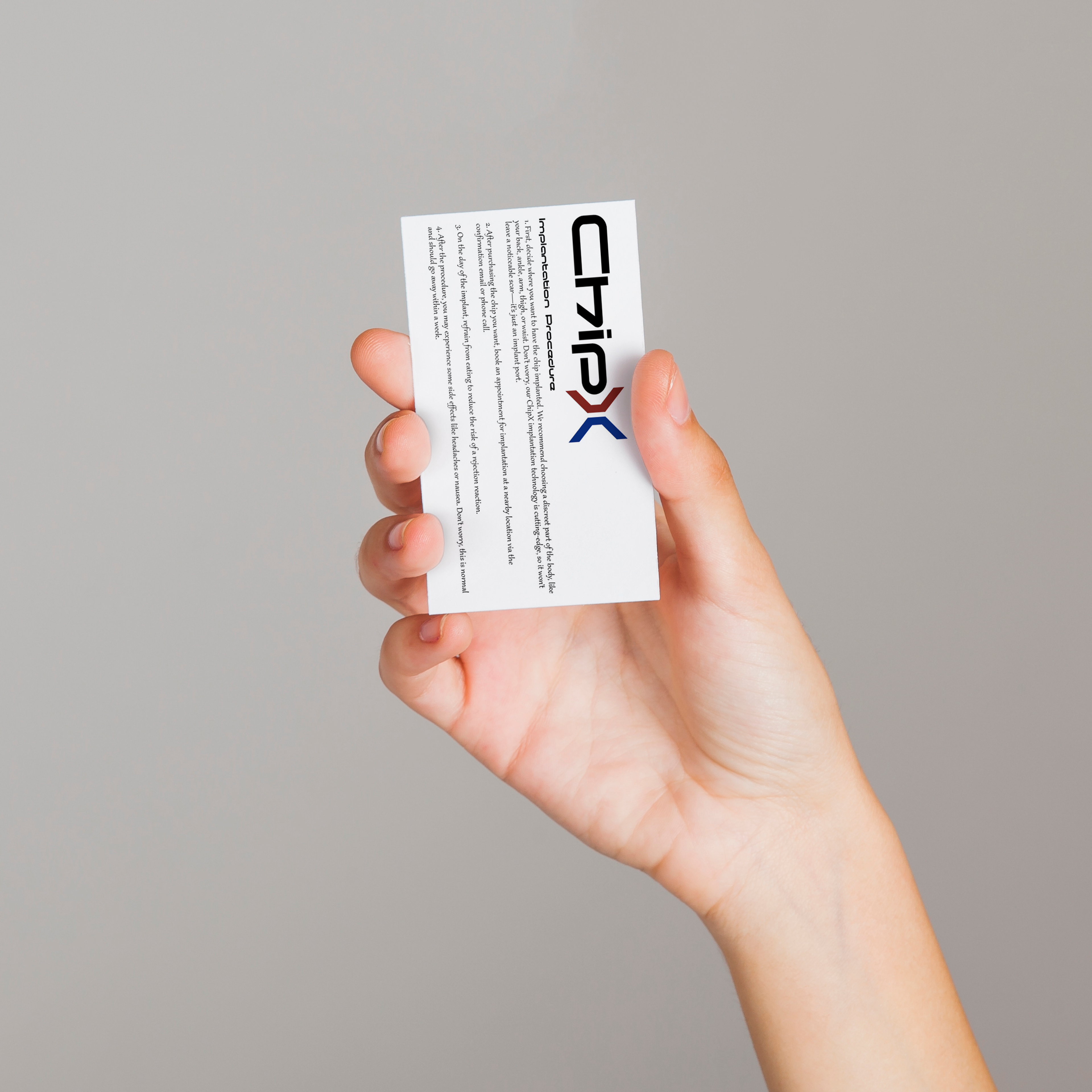 A hand holding a white business card with the "ChipX" logo printed at the top, along with smaller text below. The background is neutral grey, with the focus on the hand and card.