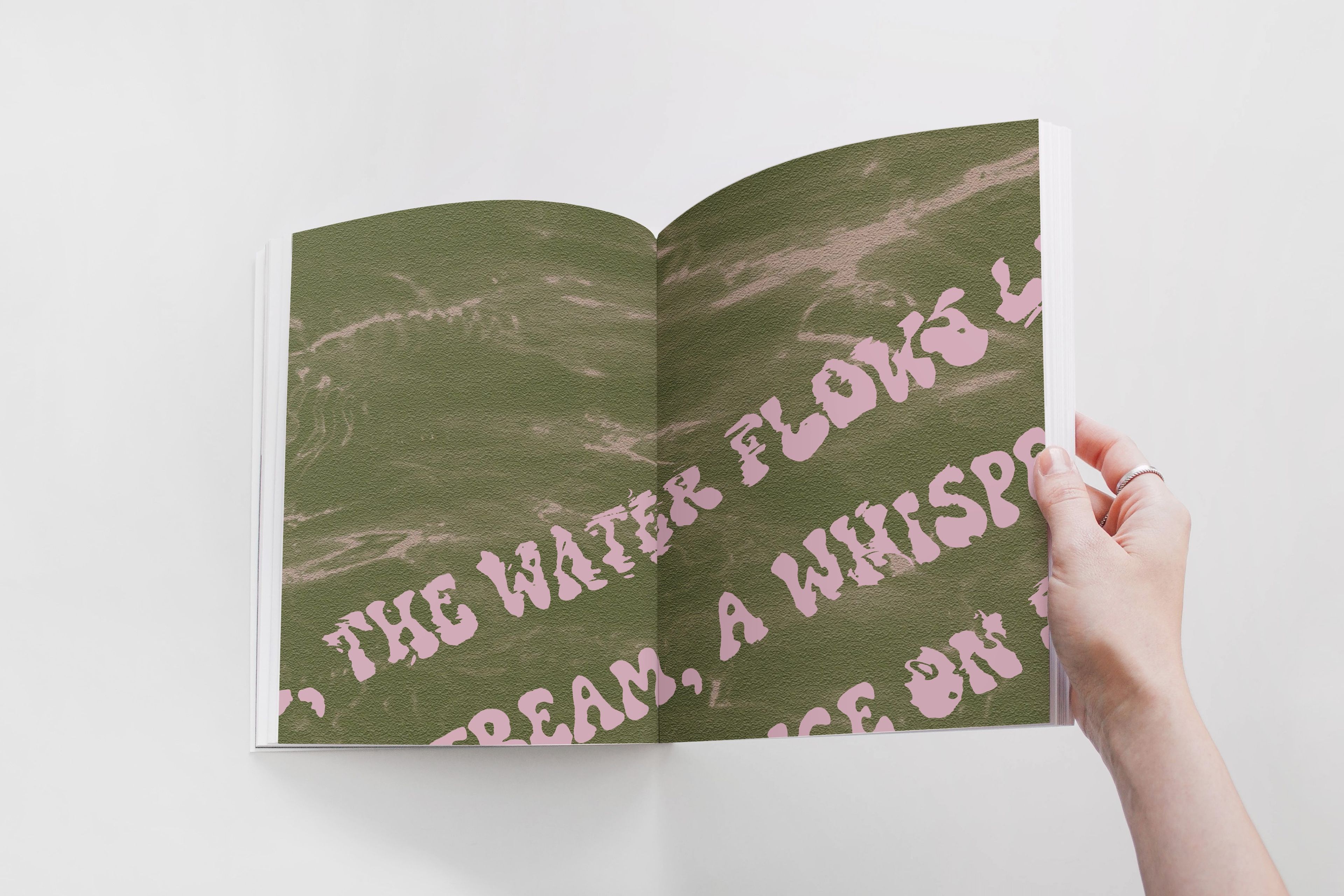 Zine page featuring pink text on a textured green background, reading 'The water flows like a whisper,' giving a tranquil, poetic feel.