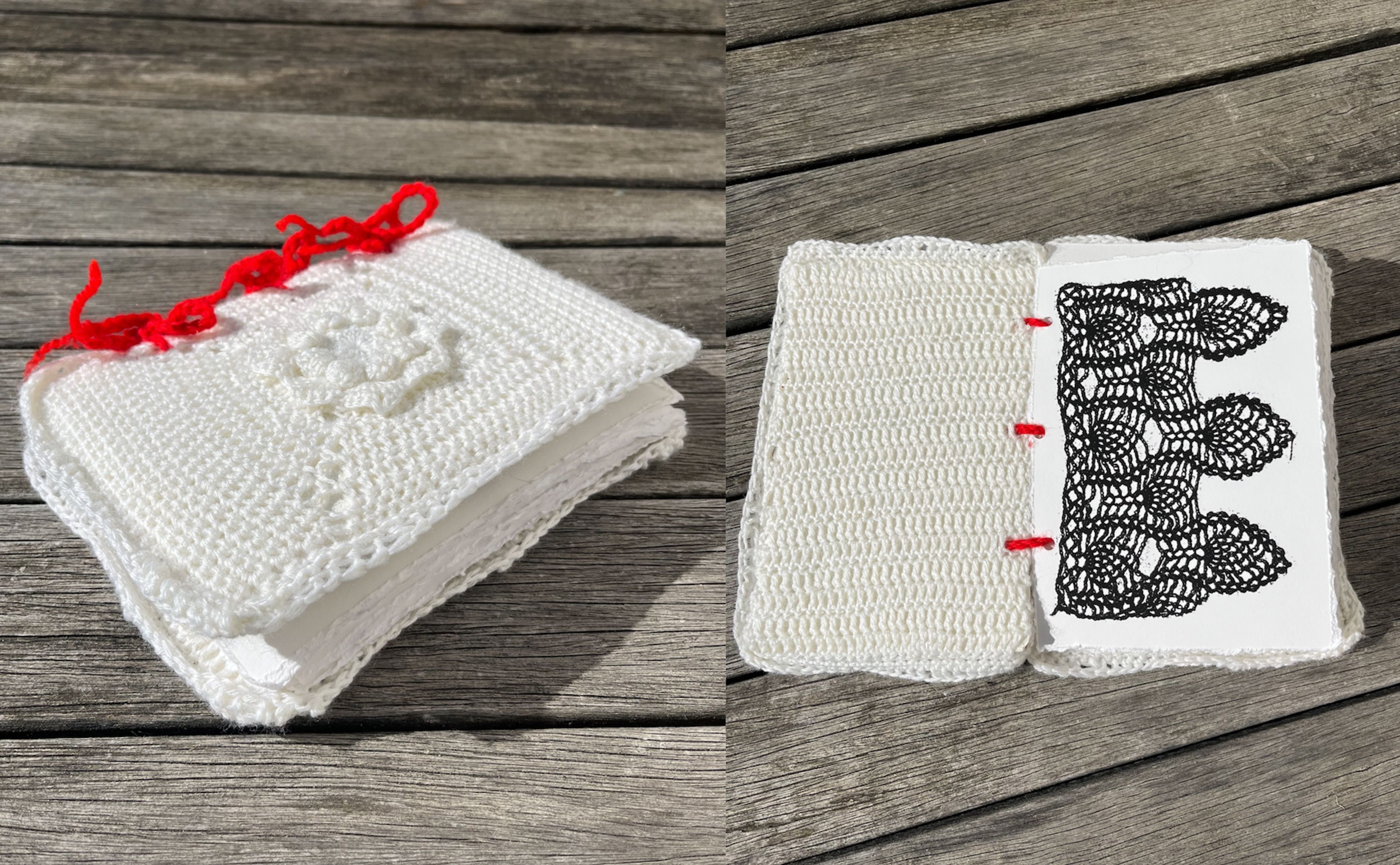 A handmade book with a crochet cover and red yarn binding on a wooden surface. The open page reveals black lace-like crochet patterns, contrasting against the white background.