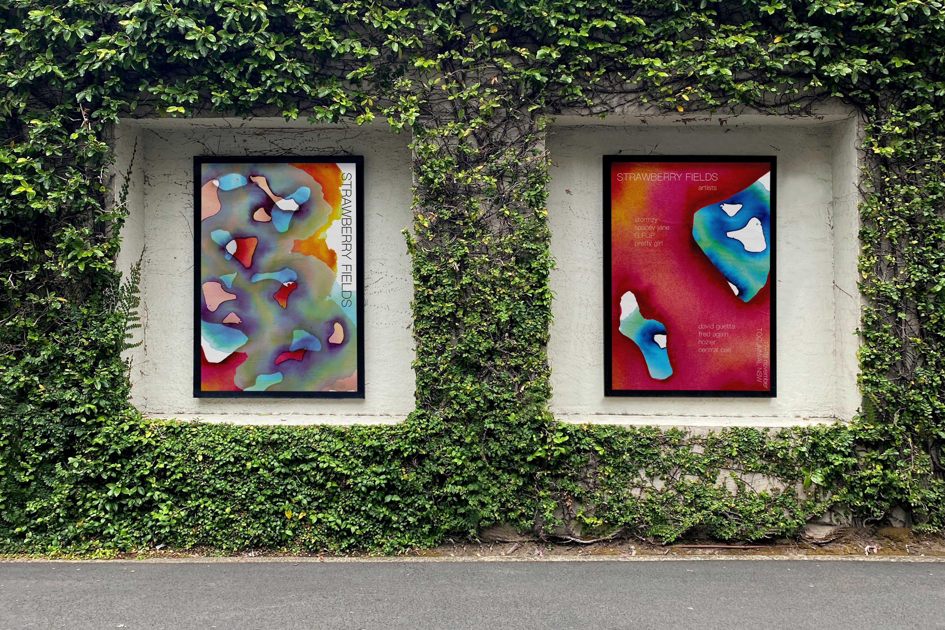 Two vibrant Strawberry Fields posters displayed within ivy-covered wall alcoves. The posters feature abstract, colorful patterns in shades of blue, pink, and orange with organic shapes. The lush green ivy frames the posters, blending nature with the bold, modern design.