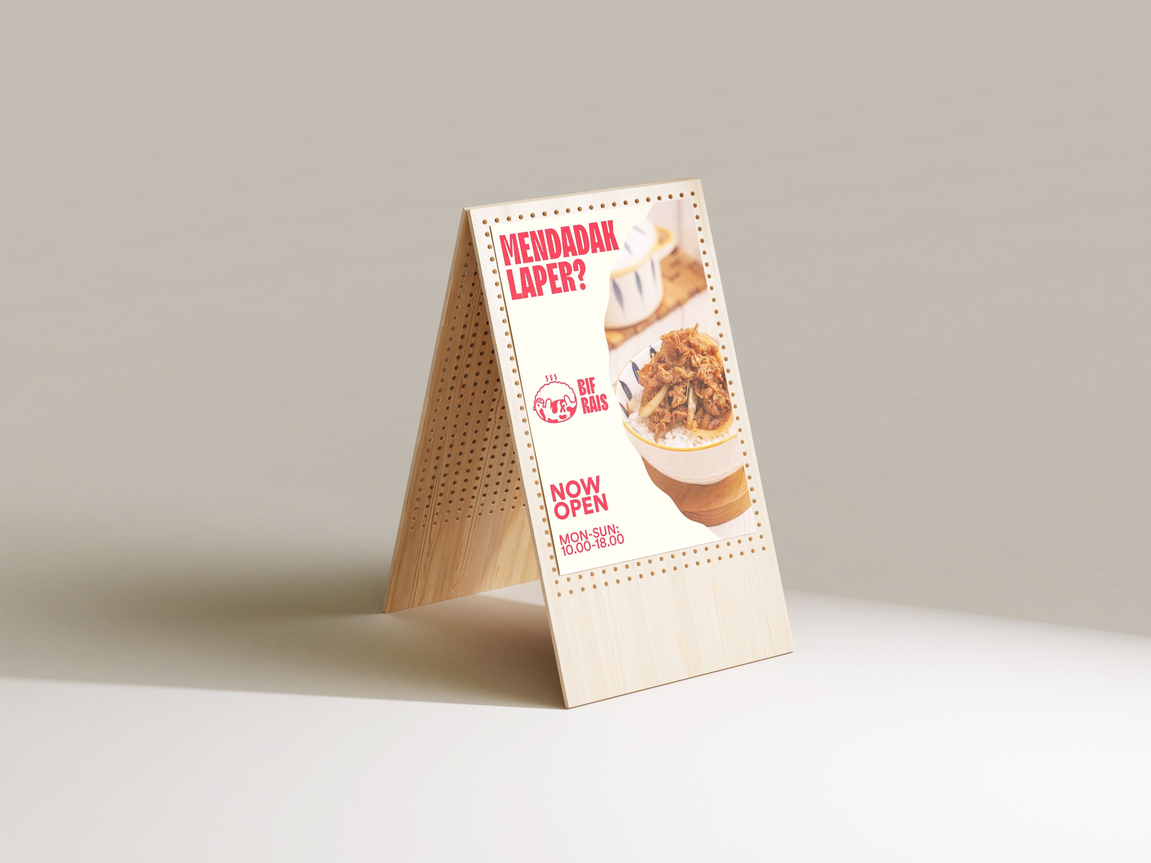 Wooden a-frame sign featuring restaurant promotion 'MENDADAK LAPER?' with perforated dot pattern border. Shows image of rice bowl with meat topping, includes 'NOW OPEN' text and operating hours '10.00-18.00 MON-SUN'.