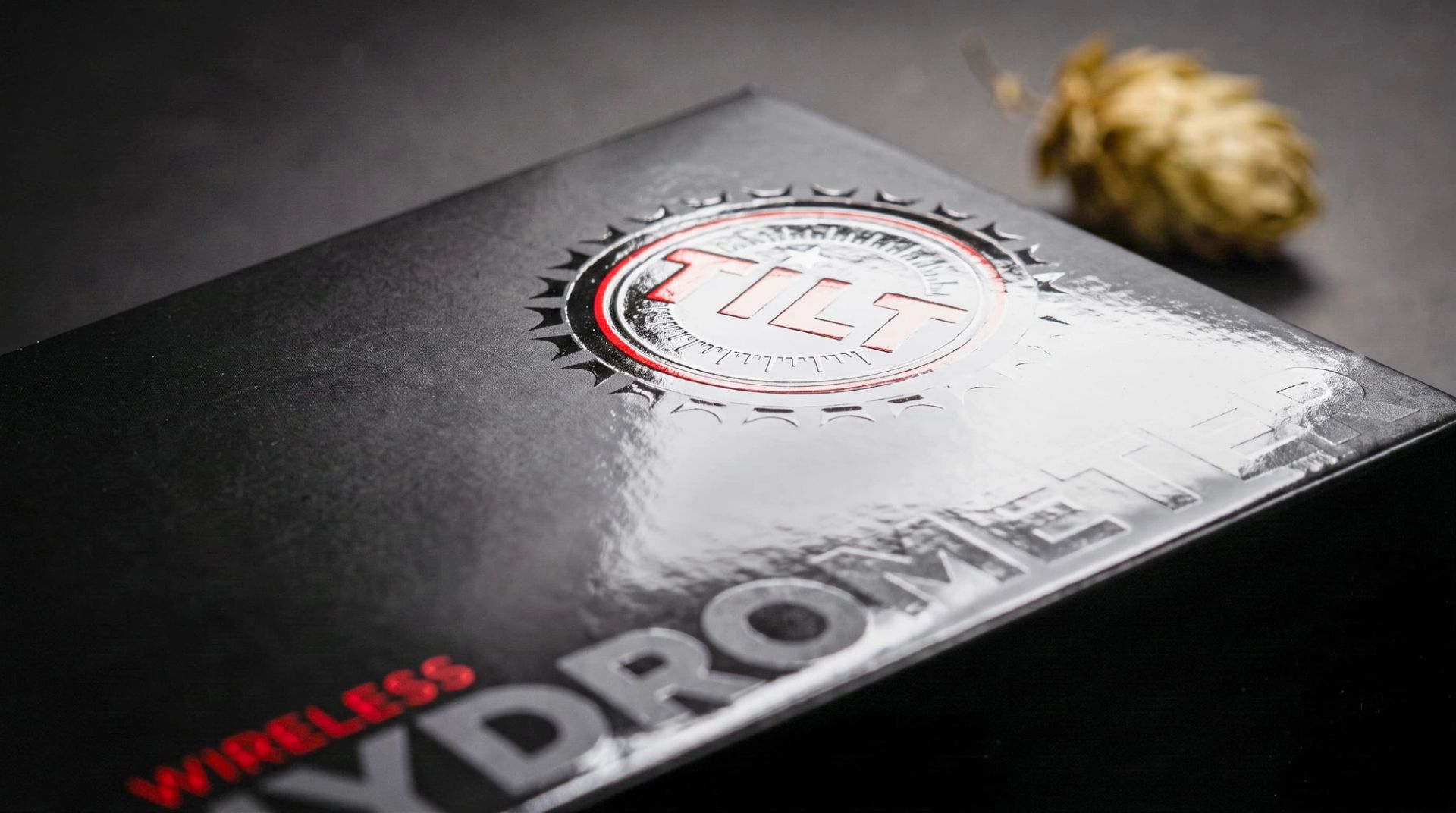 Close-up of the black TILT Wireless Hydrometer box showing spot UV gloss finishing on the logo and typography.