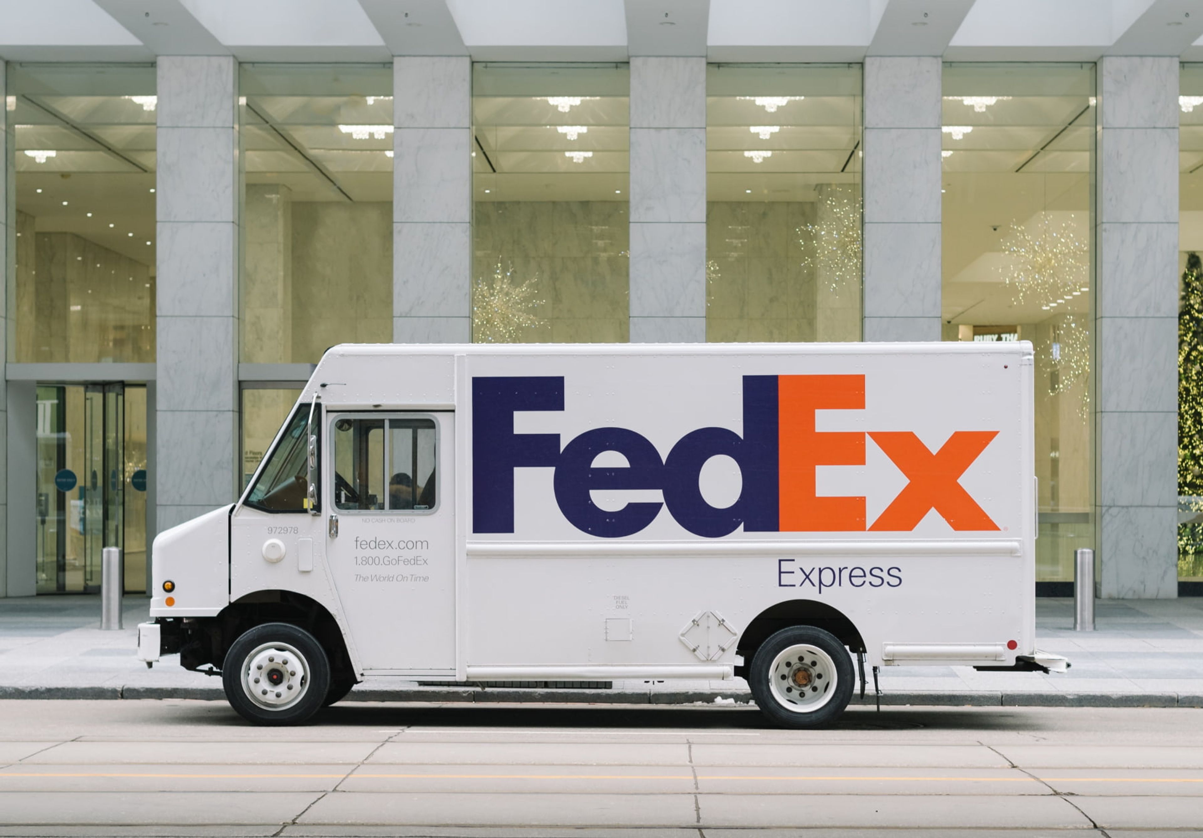 Fed-ex delivery truck in front of building.