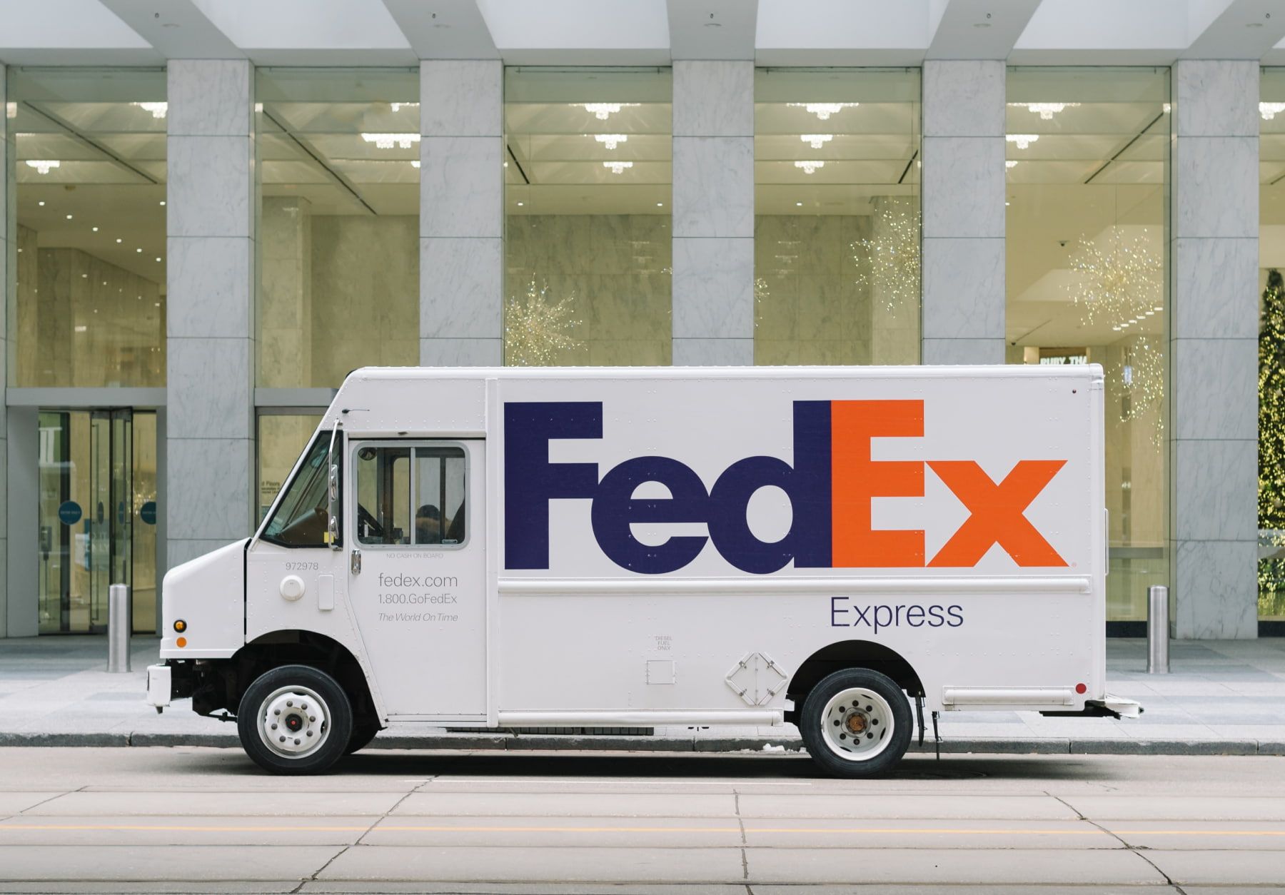 Fed-ex delivery truck in front of building.