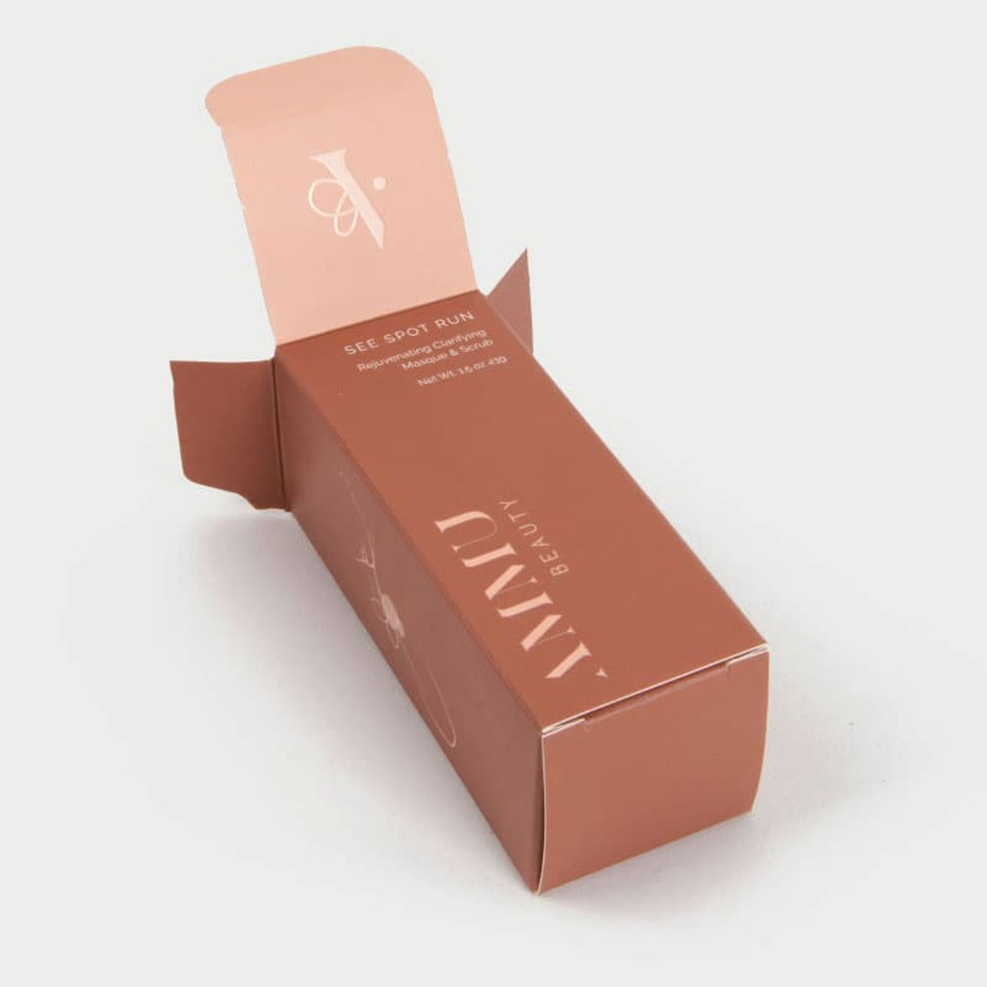 Open terracotta Ammu Beauty box showing the top flap with a printed logo on the inner lid.