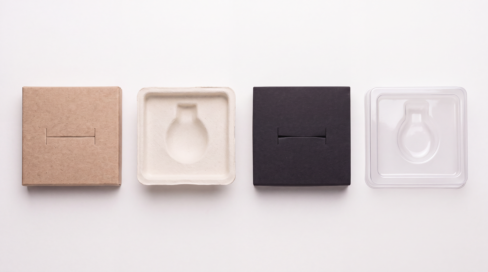 Four jewelry inserts in a row: die-cut kraft card, molded pulp, black foam, and clear vacuum-formed plastic.