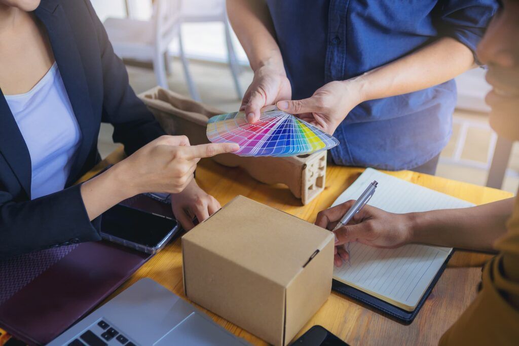 Designers working
on graphic packaging design with color chart and materials