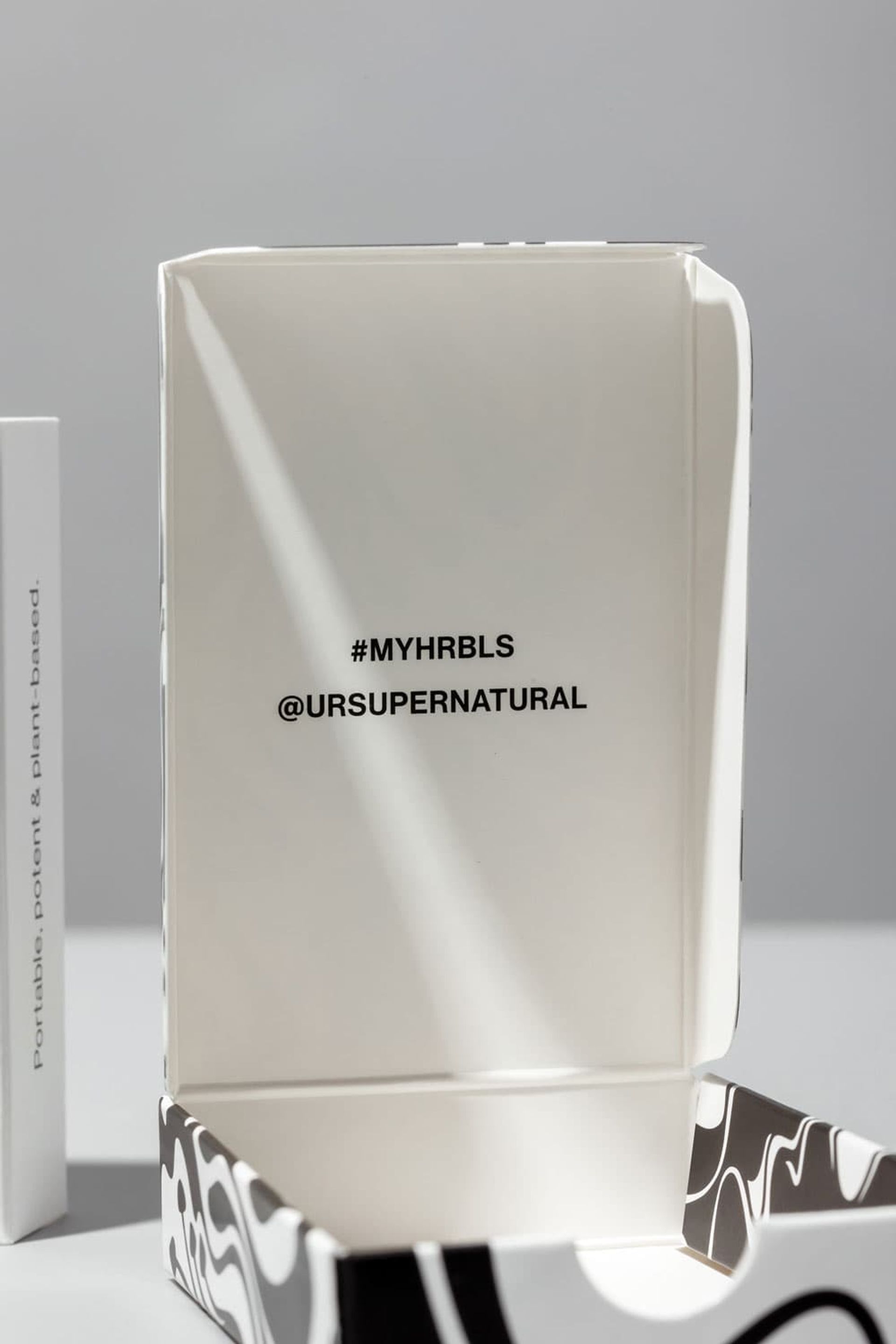 Close-up of an open HRBLS box showing custom printed social media handles on the inside lid.