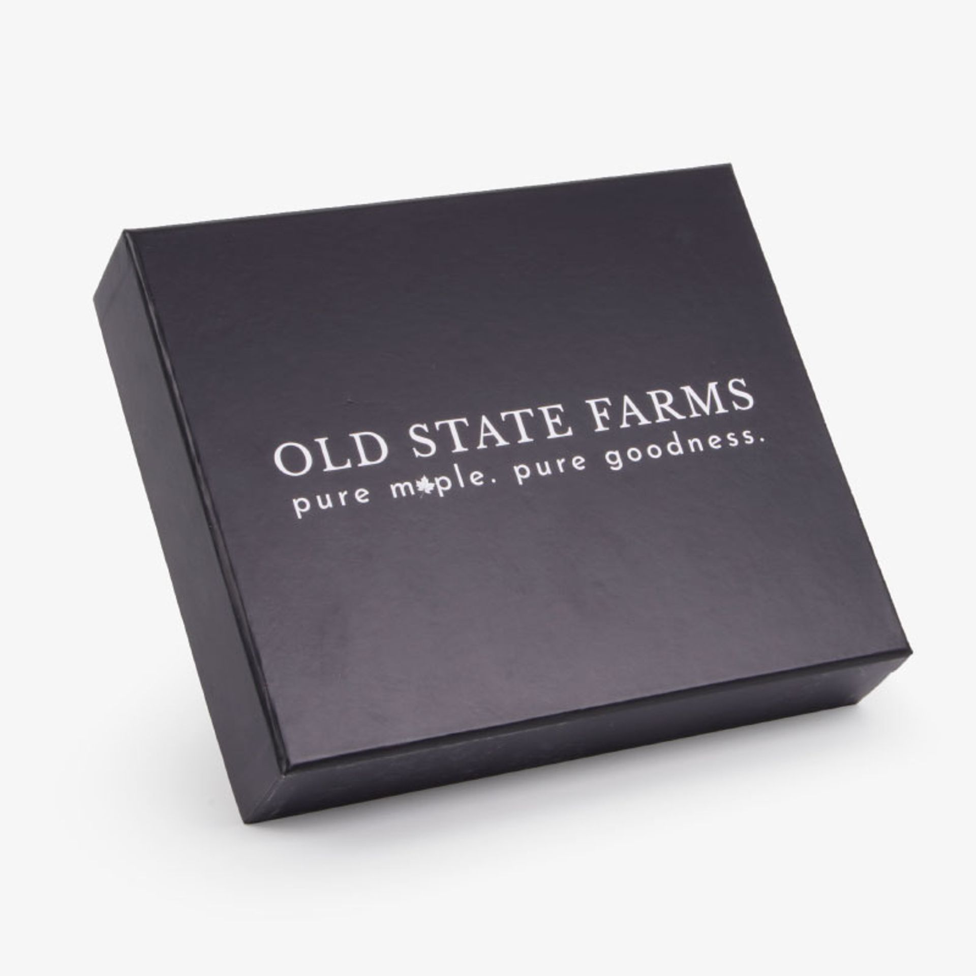 Closed black two-piece Old State Farms box featuring white logo text: "pure maple. pure goodness."