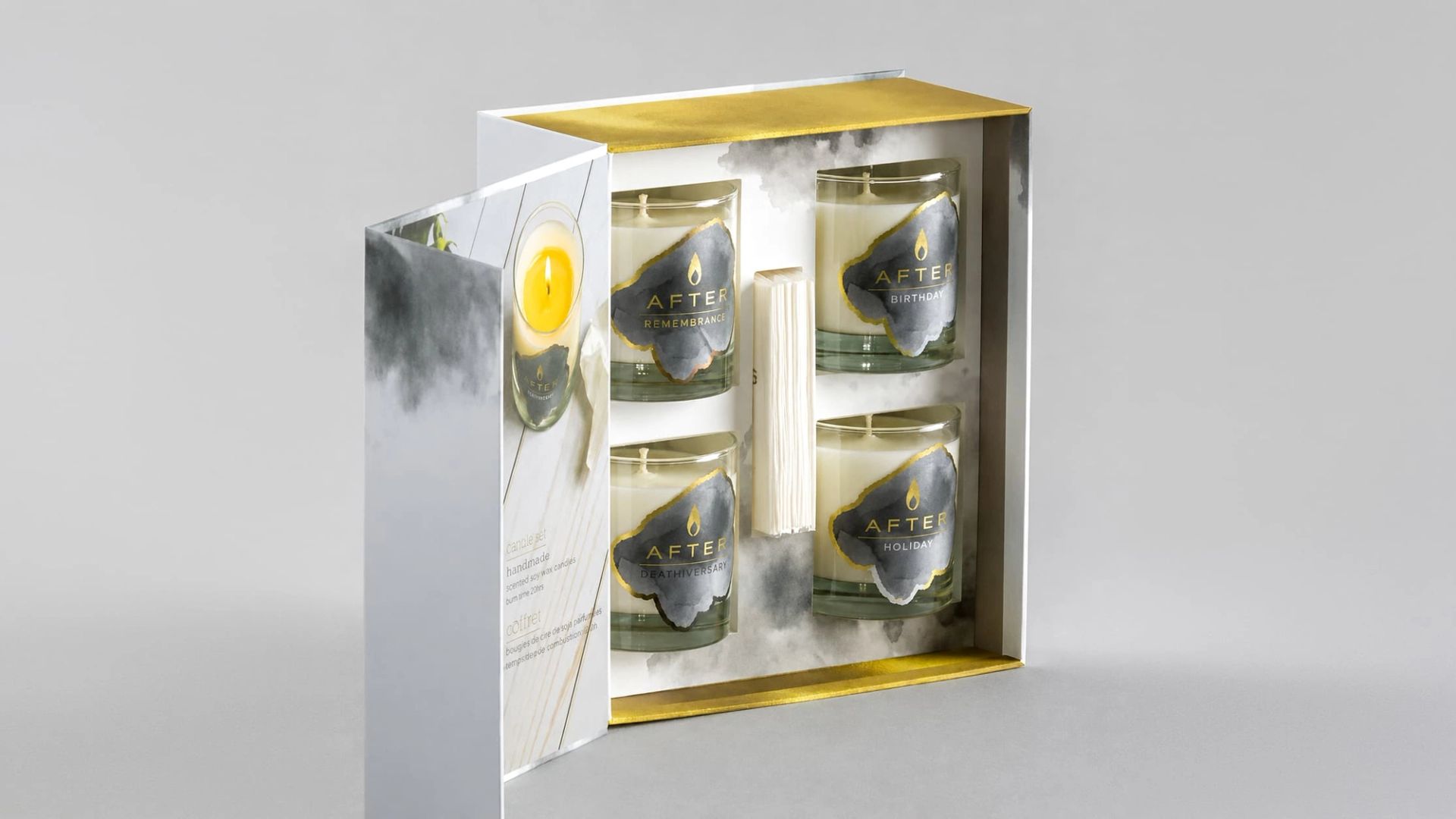 Open Luminous Box displaying four labeled glass candles and a tissue pack set securely in a white box insert.