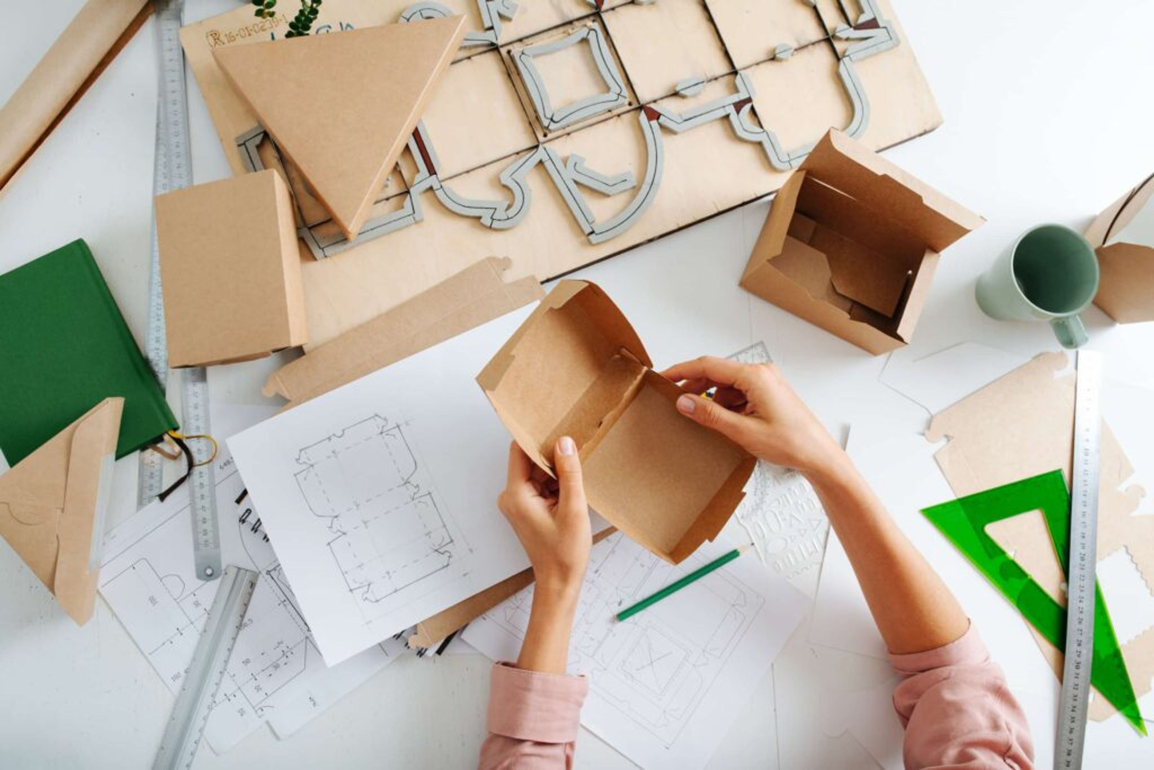 Top view of woman hand with box, designing new packaging