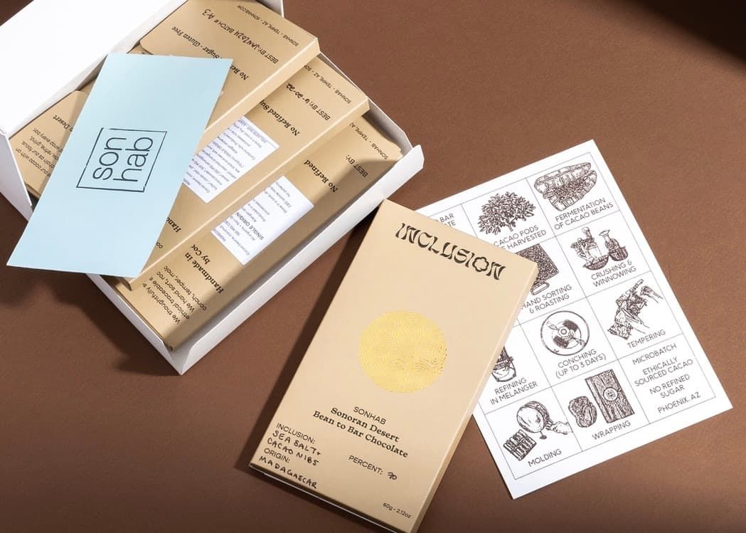 Scattered Sonhab packaging including an Inclusion box, mailer, QR card, and illustrated bean-to-bar process inserts.