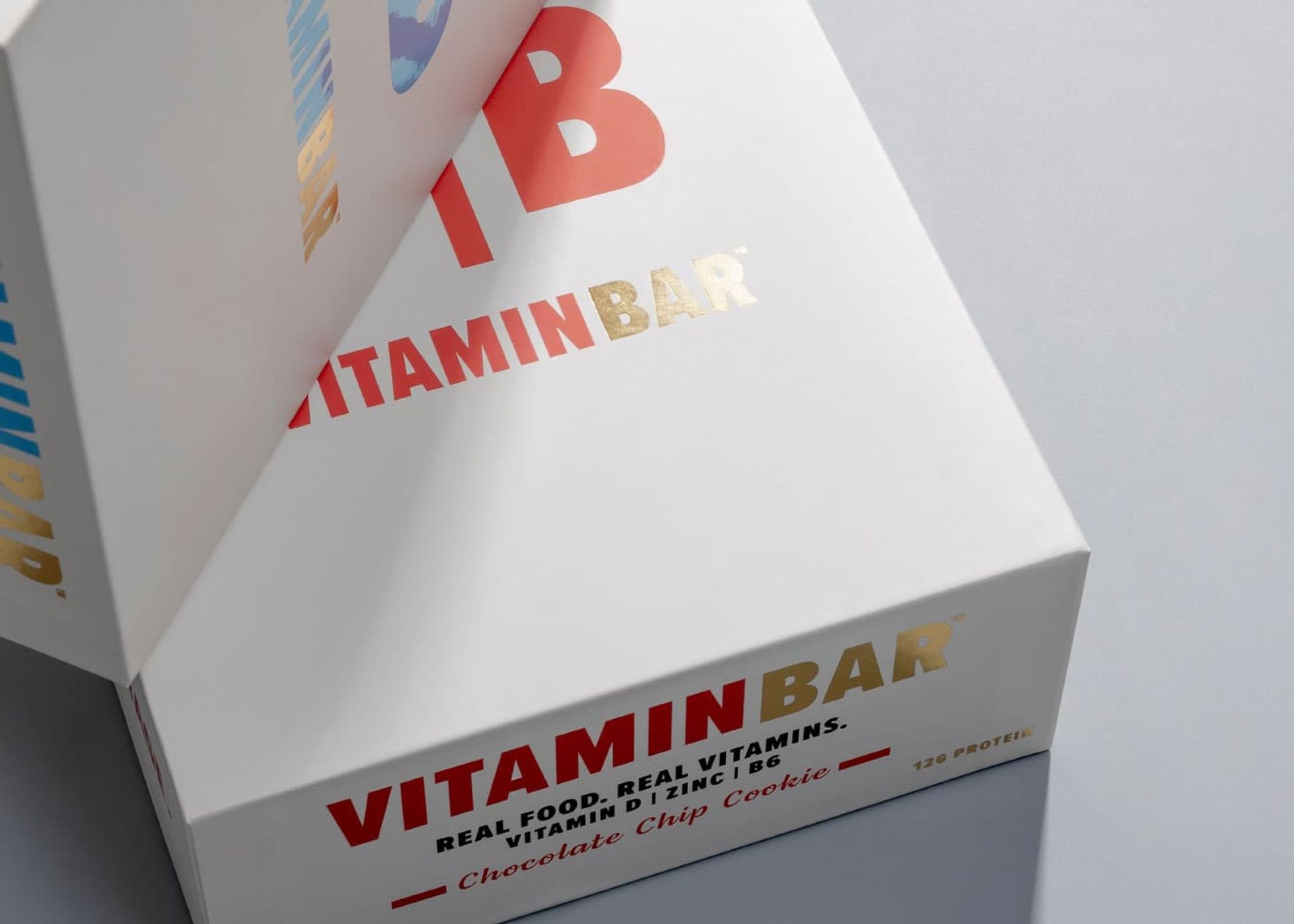 Close-up of a white Vitamin Bar box highlighting metallic gold foil stamping and clean, crisp typography.