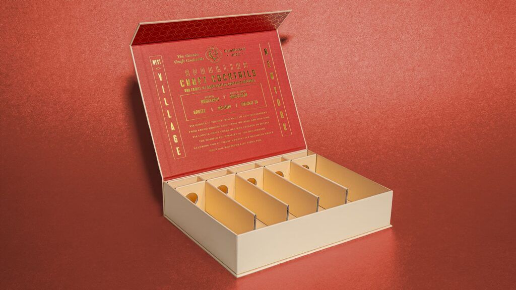 Open Via Carota magnetic rigid box displaying its 5-slot cream corrugated insert and red gold-foiled lid.