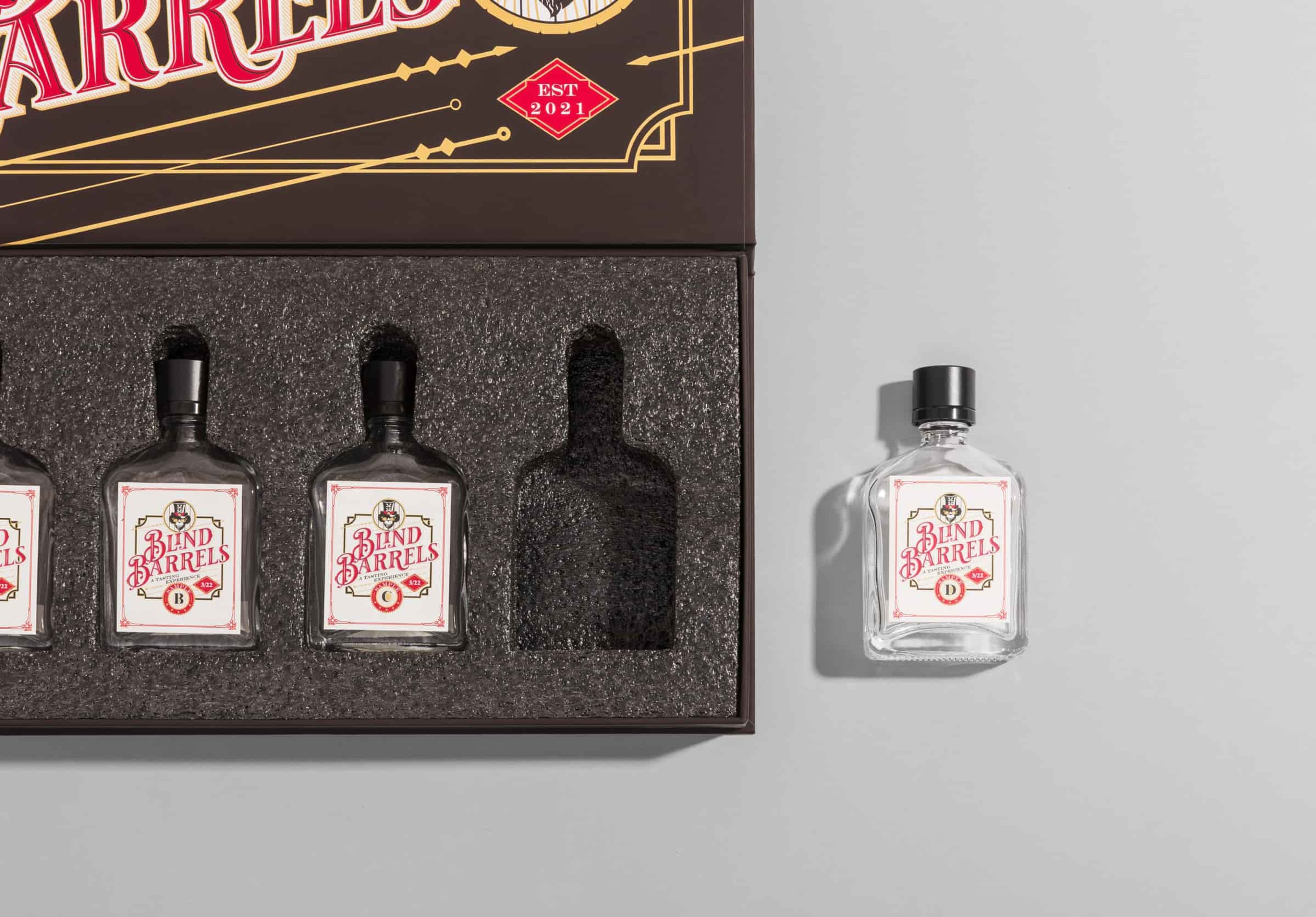 Black rigid box with black foam insert for whiskey glass bottles.