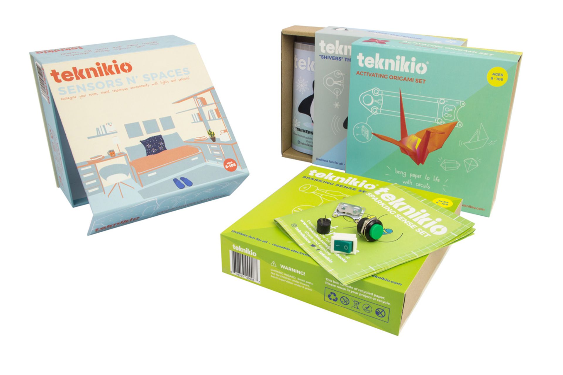 Three Teknikio educational kits of varying sizes, featuring colorful packaging and small electronic components.