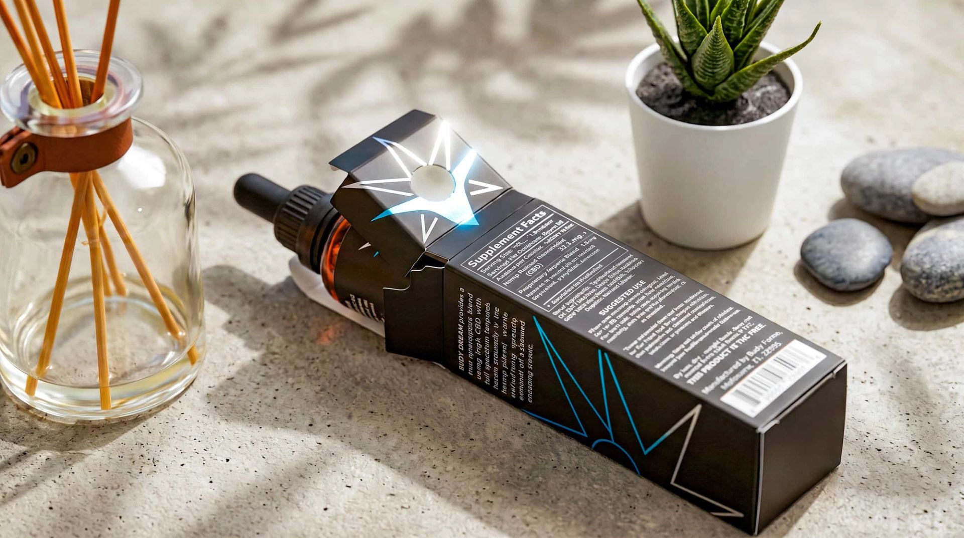 A Budy Farms Dream CBD box lying on its side, showing the back panel's supplement facts and an open top flap.