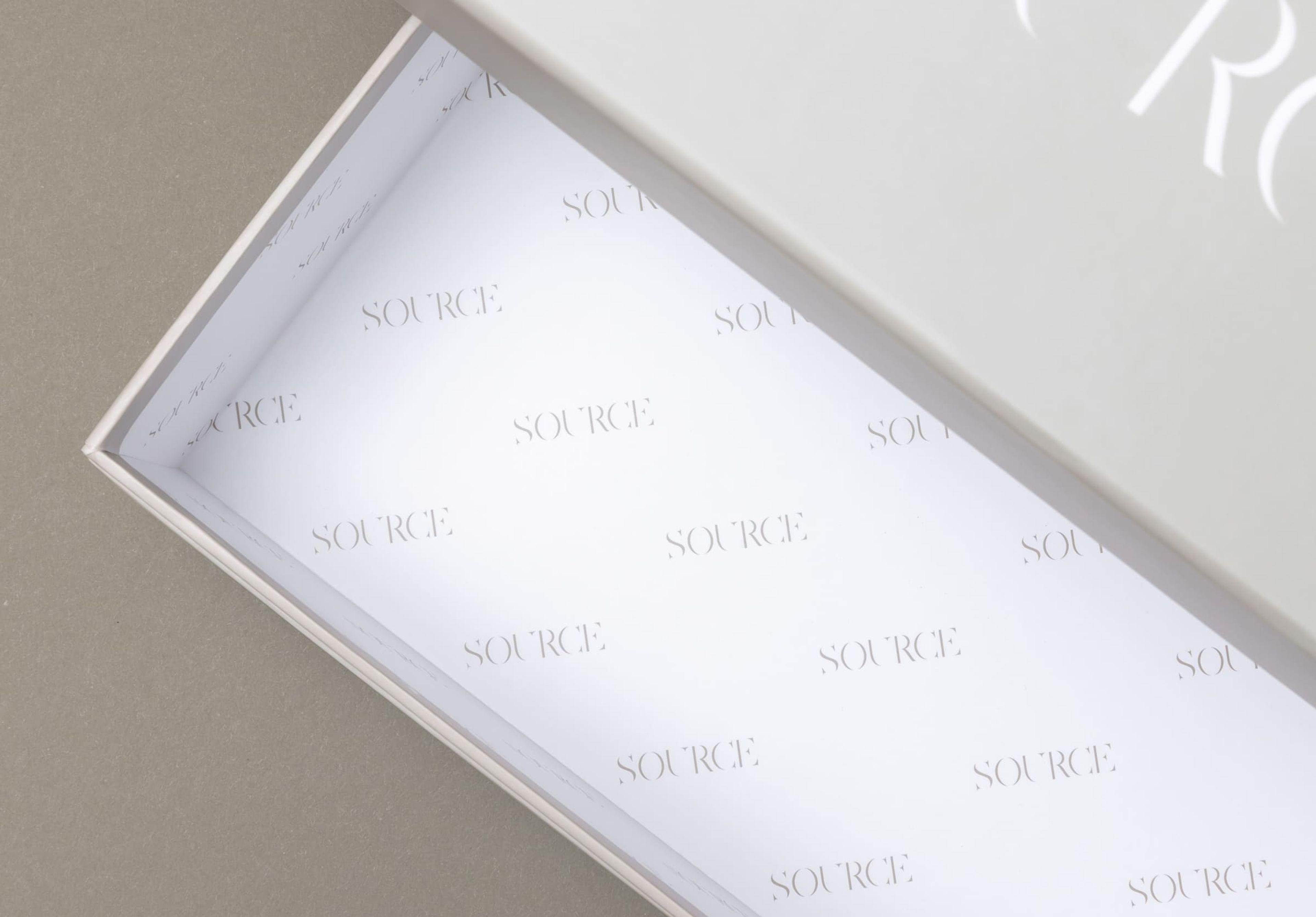 Source packaging rigid box with interior printing.