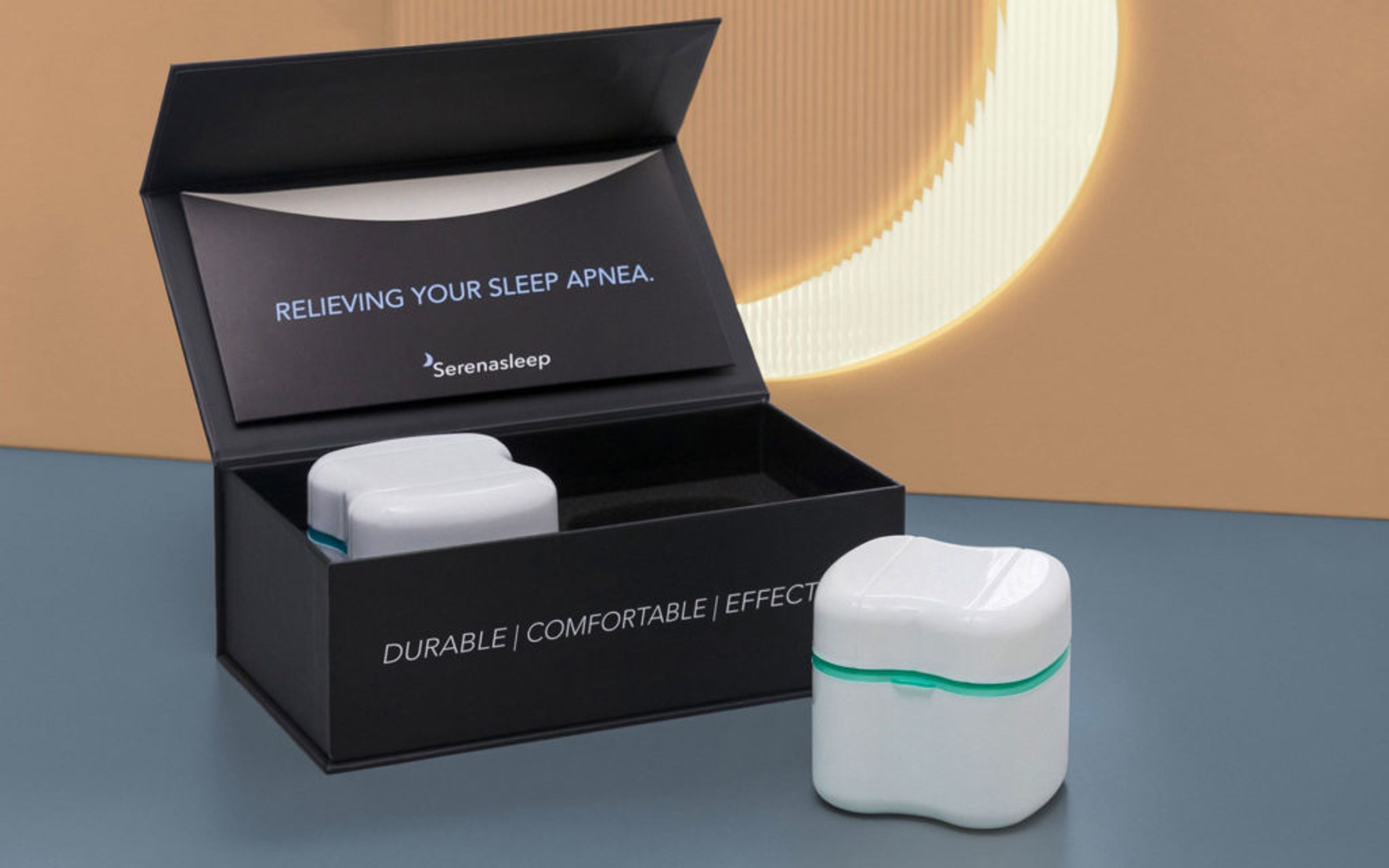 Open black Serena Sleep box with a white device case in a custom foam insert, alongside a second case resting outside.