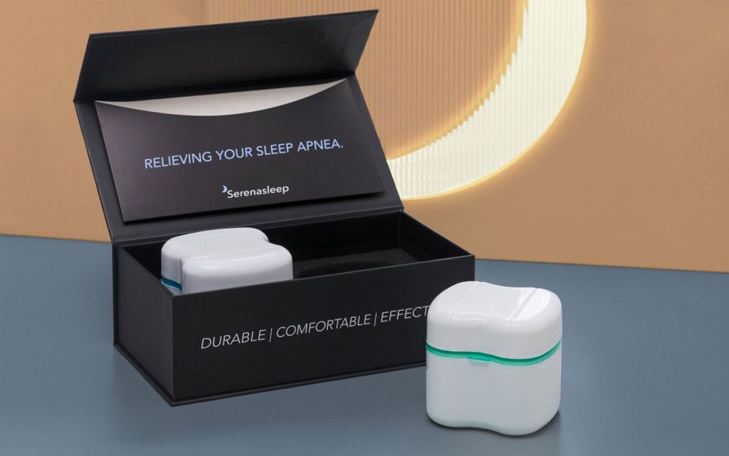 Open black Serena Sleep box with a white device case in a custom foam insert, alongside a second case resting outside.