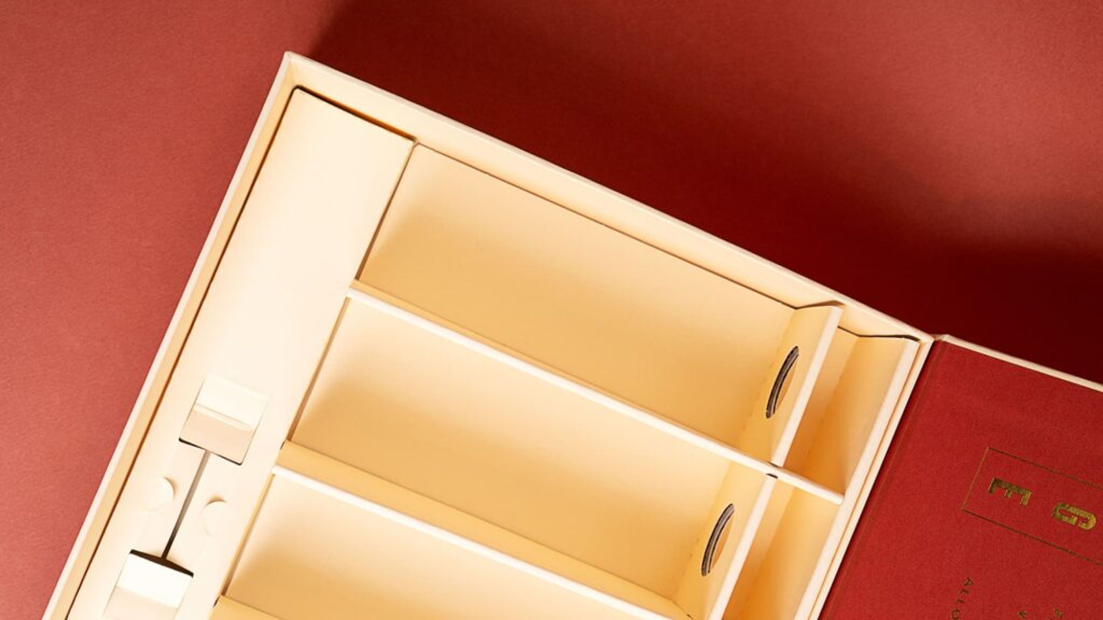 Angled view of the open cream Via Carota gift box showing custom corrugated paper dividers.