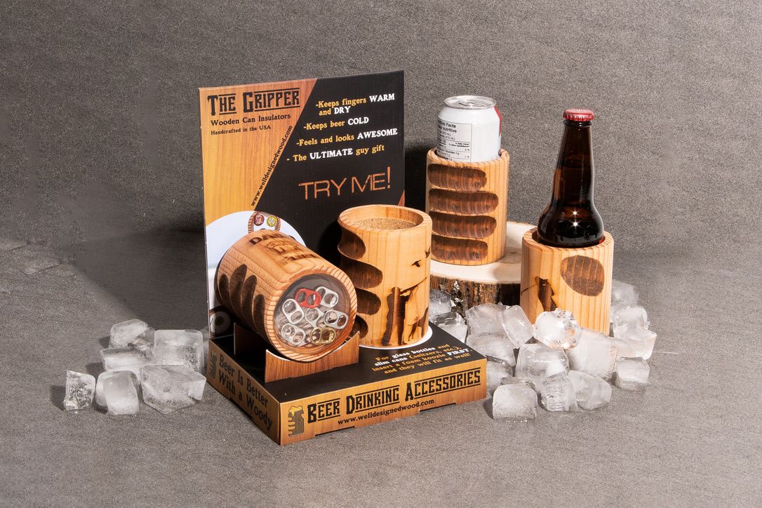 The Gripper wooden can insulators in a retail POP display holding a beer bottle and can among ice.