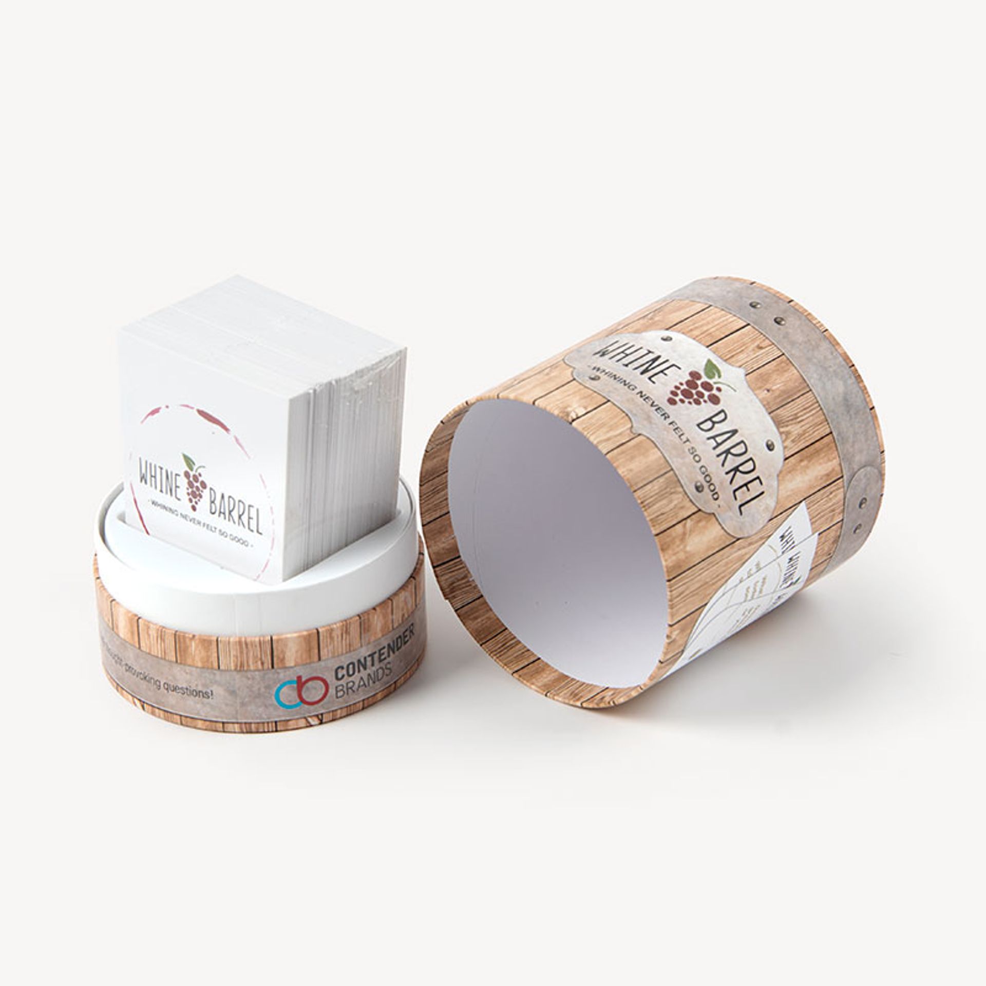 An open Whine Barrel card game tube with wine barrel graphics and a deck of cards sitting inside.
