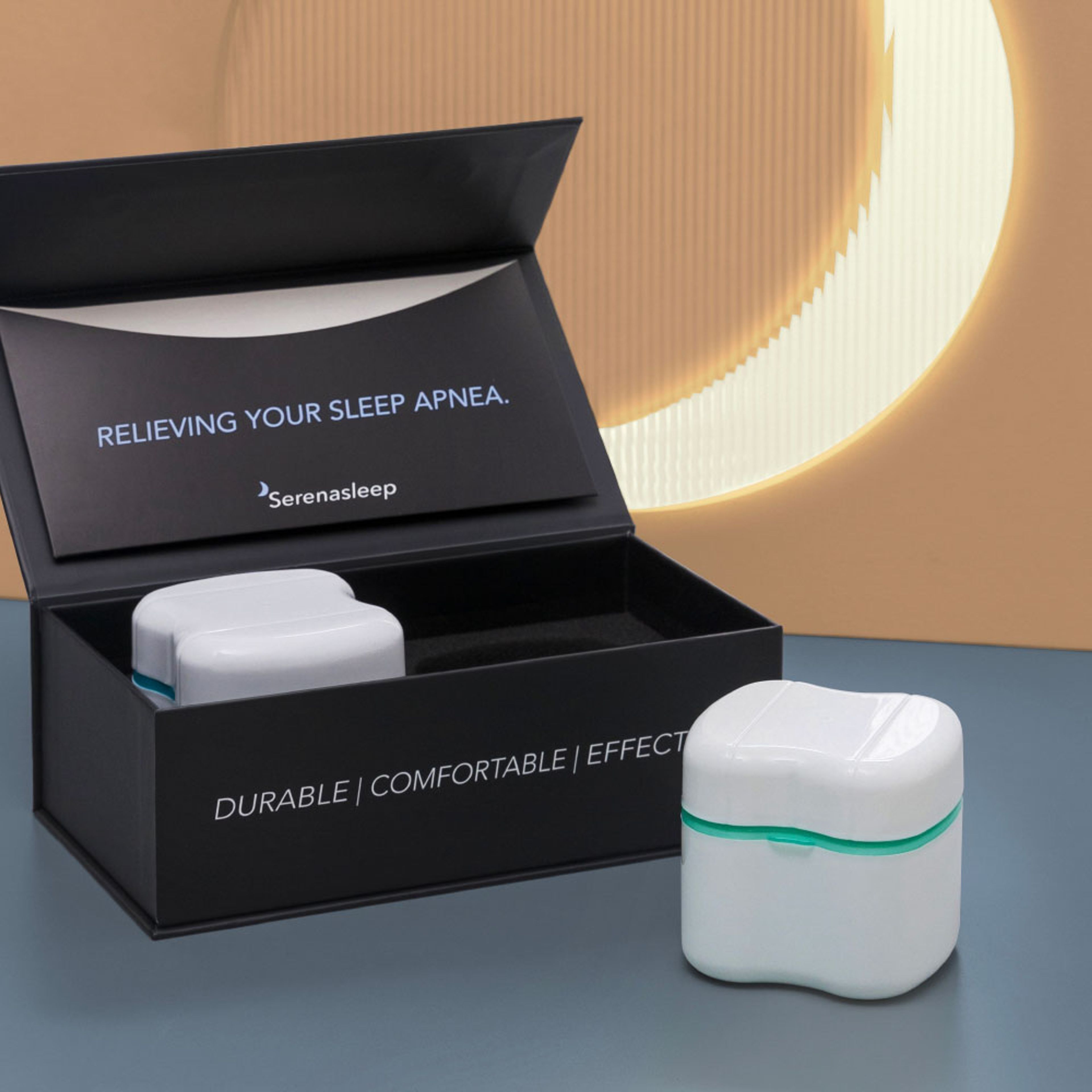 Open black Serena Sleep box with a white device case in a custom foam insert, alongside a second case resting outside.