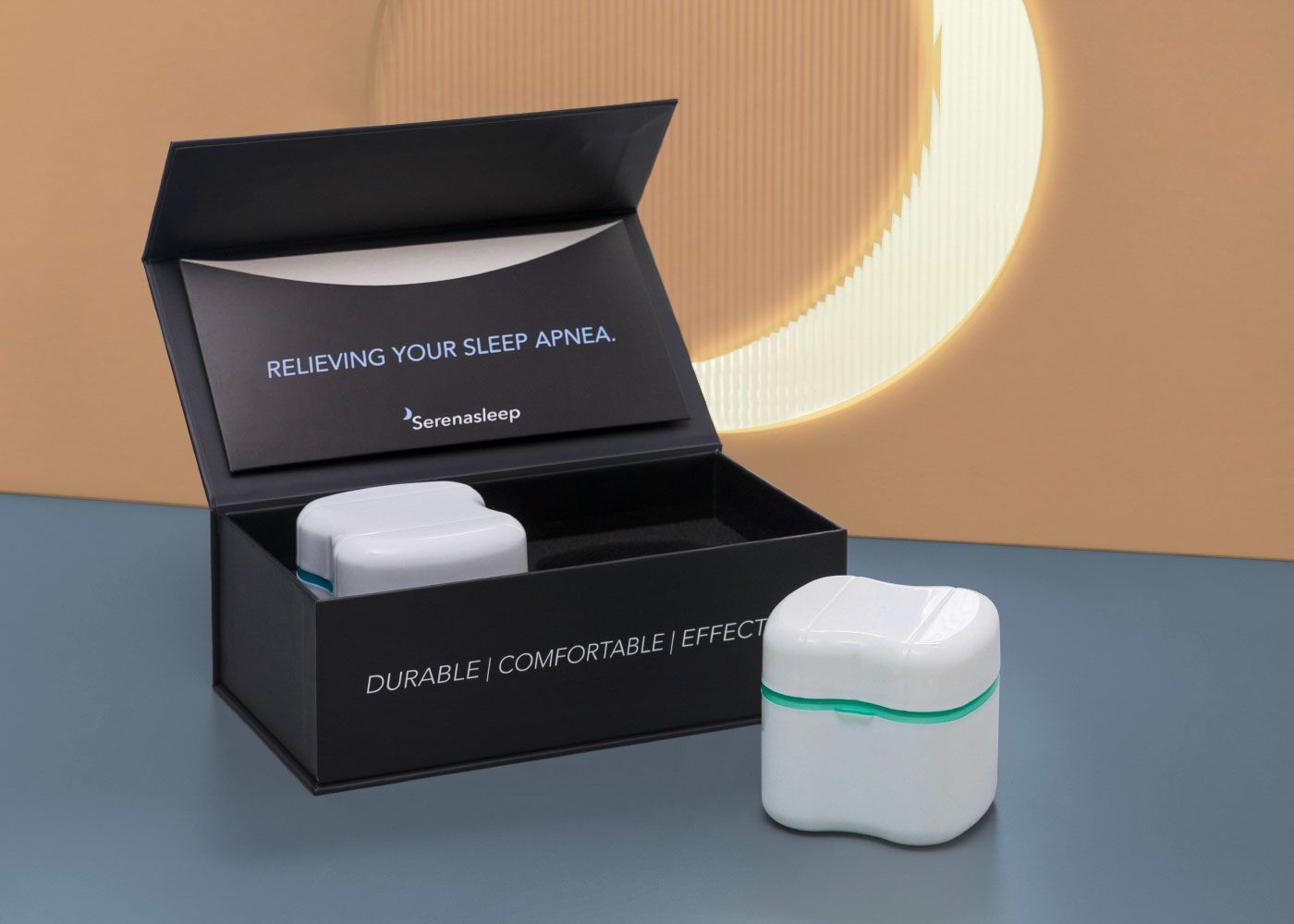 Open black Serena Sleep box with a white device case in a custom foam insert, alongside a second case resting outside.