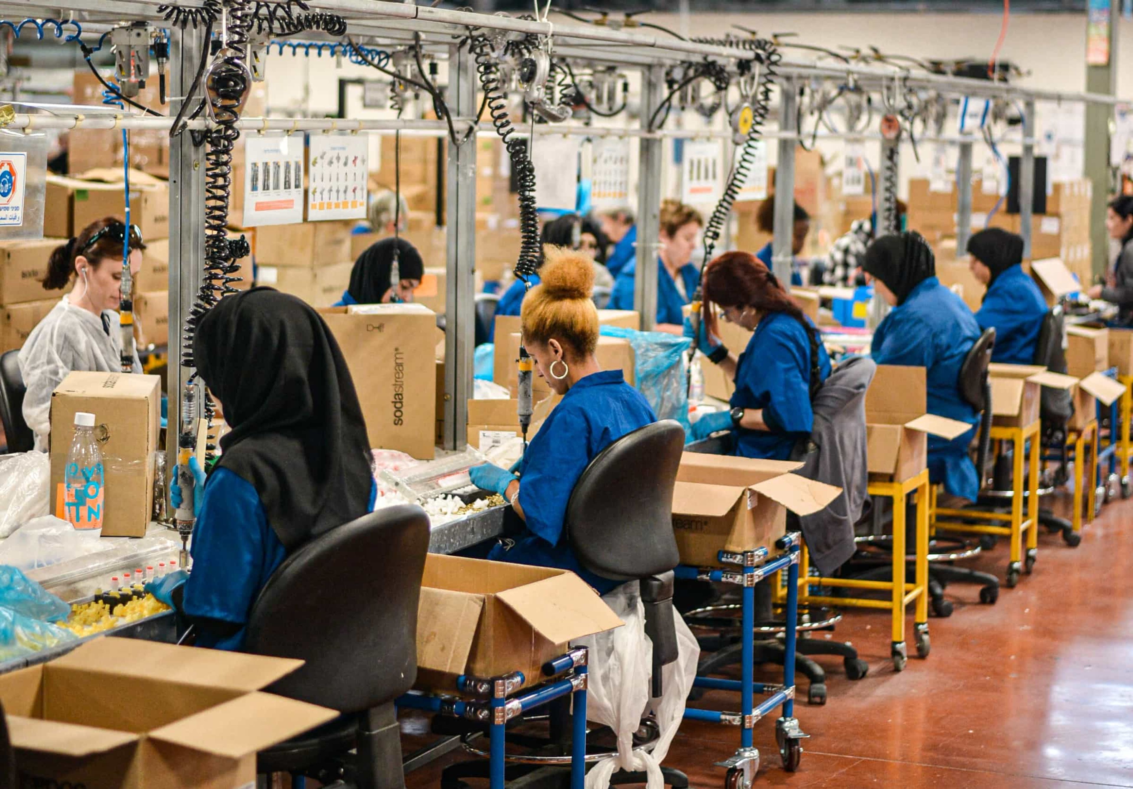 Women working on quality check at a factory.